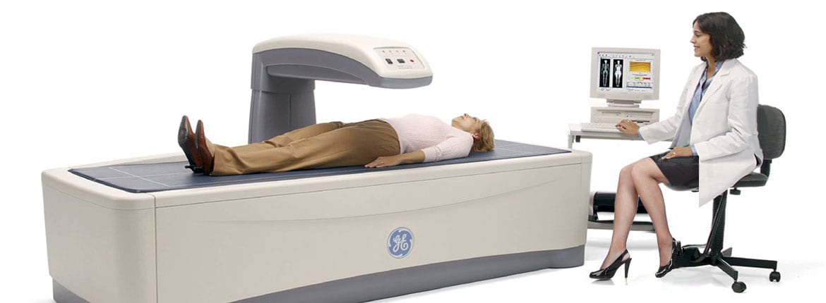 bone-density doctor doin a bone density checkup on a woman patient