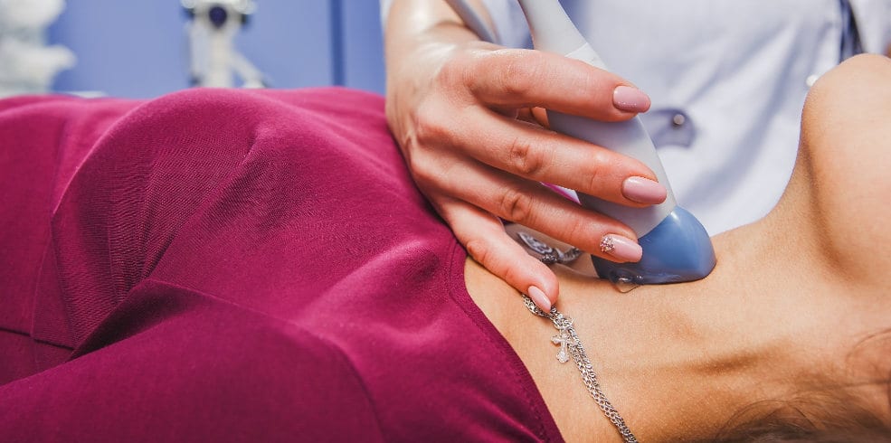 Young Woman Doing Neck Ultrasound Examination Young Woman Doing Neck Ultrasound Examination