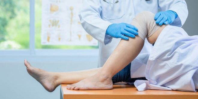 close-up-hand-wear-medical-gloves-doctor-examining-head-patient-with-knee-problems-clinic